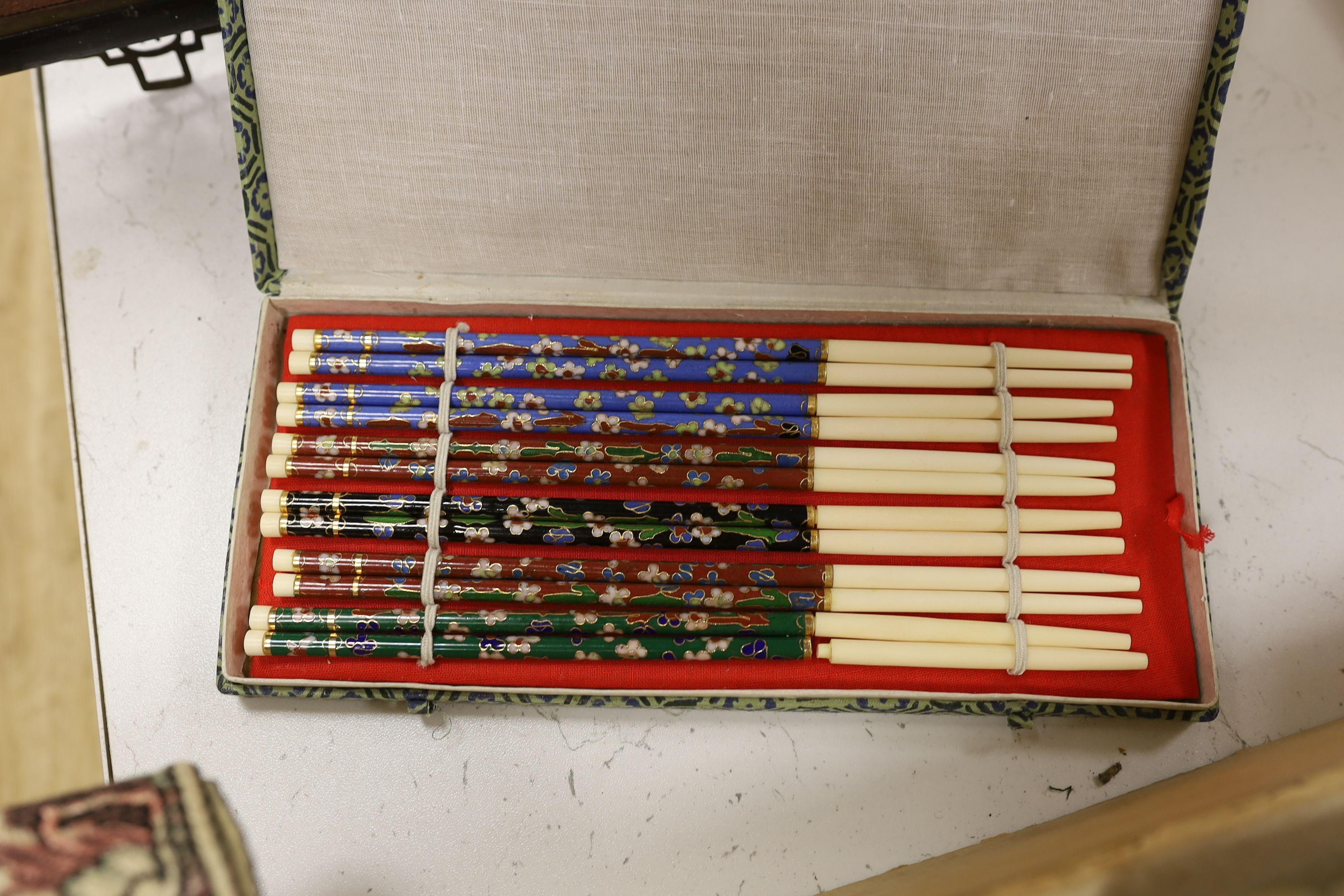 Two Chinese carved gilt wooden panels, a cased set of chopsticks, a boxed silk woven scroll and lacquer mahjong stands, a hand scroll and silk embroidery